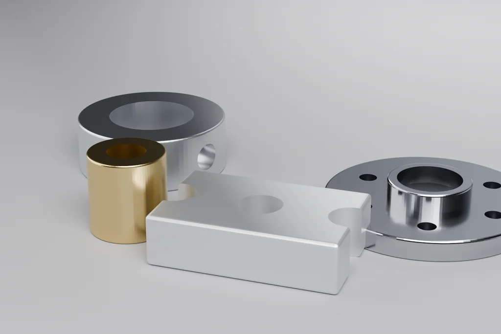 Four machined parts arranged on a bench: a turned collar, a brass bushing, a milled block and a flanged hub.