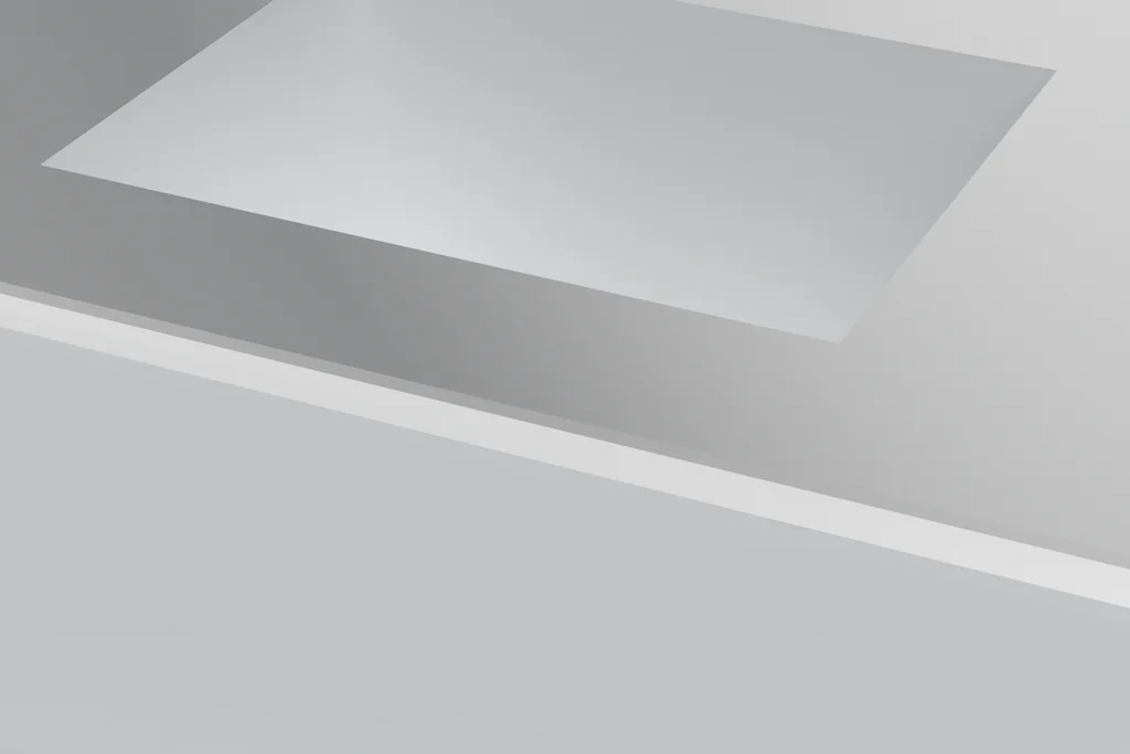 Close view of a milled housing showing a rectangular pocket, a through bore and a bevelled edge.