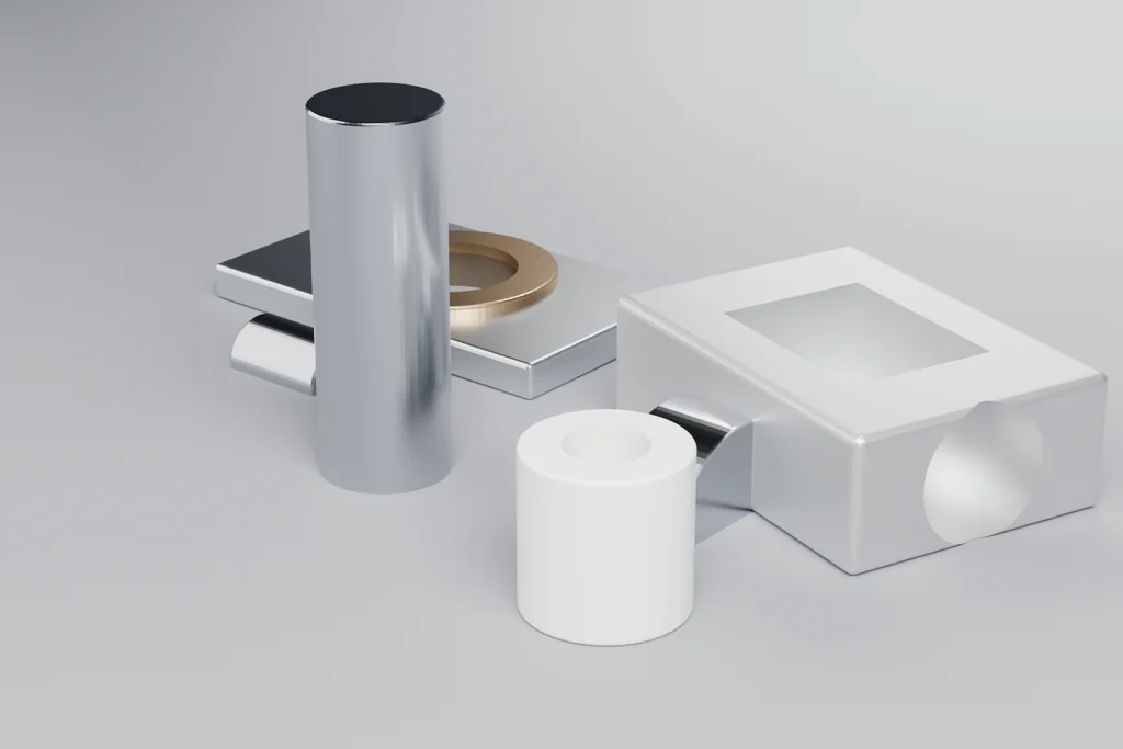 Four machined parts on a bench: a stepped shaft, a milled housing with a pocket, a mounting plate with a bronze boss and a nylon bushing.
