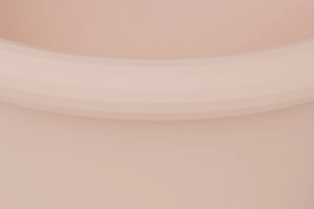 Close view of a terracotta planter showing the rolled rim, the tapered wall and the drainage hole.
