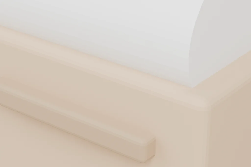 Close view of a bench void-fill dispenser showing the folded body, the roll spindle and the serrated tear edge.