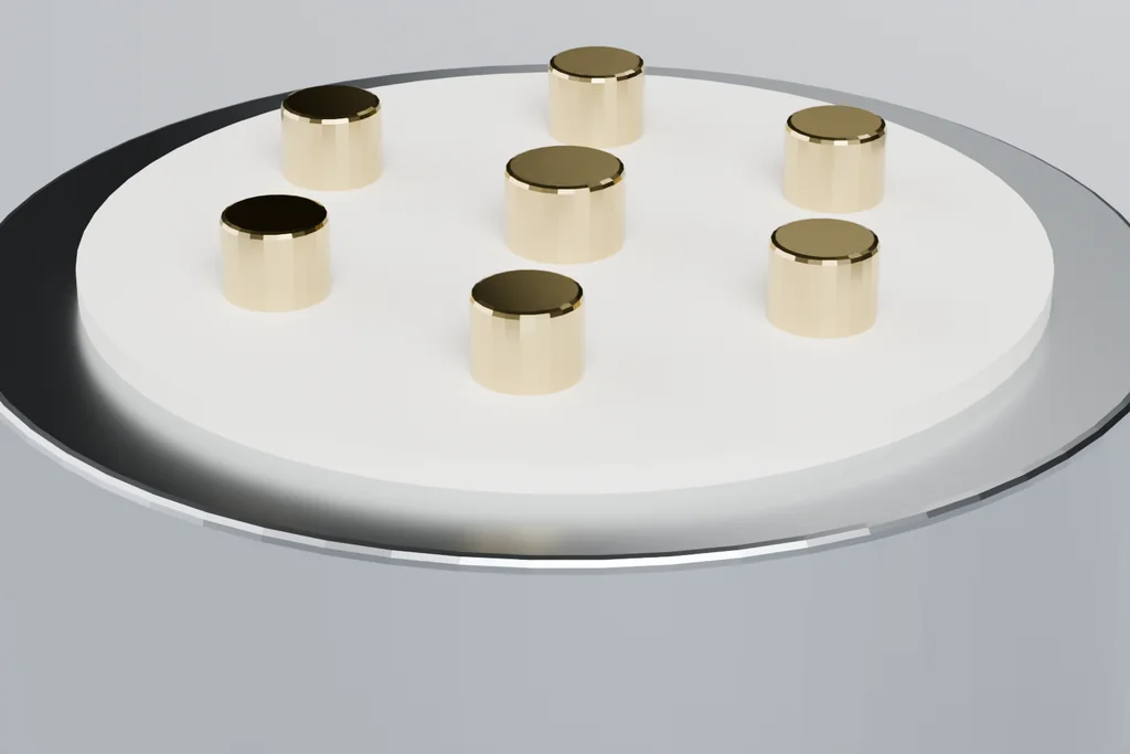 Close view of a circular connector showing the shell, the keyway, the insulator face and the gold contacts.