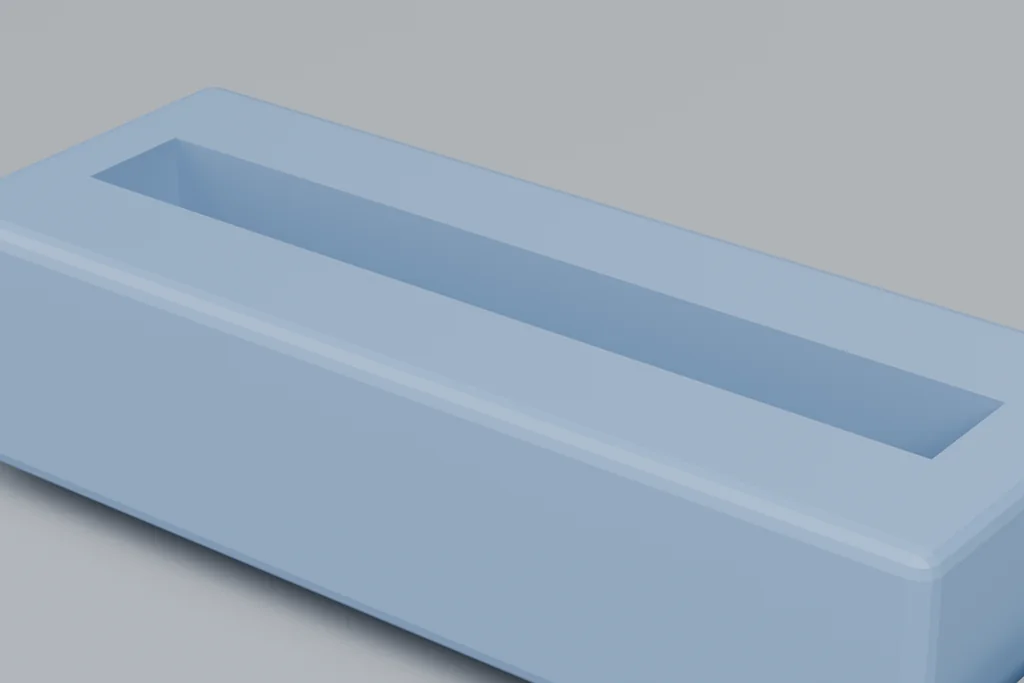 Close view of a ribbon IDC connector showing the ribbon slot, the contact row and the latches.