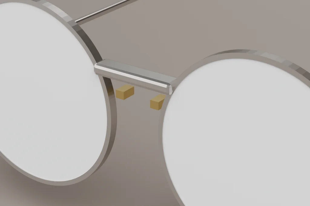 Close view of a rimless mount showing the lens edge, the bridge fixing and the end piece.