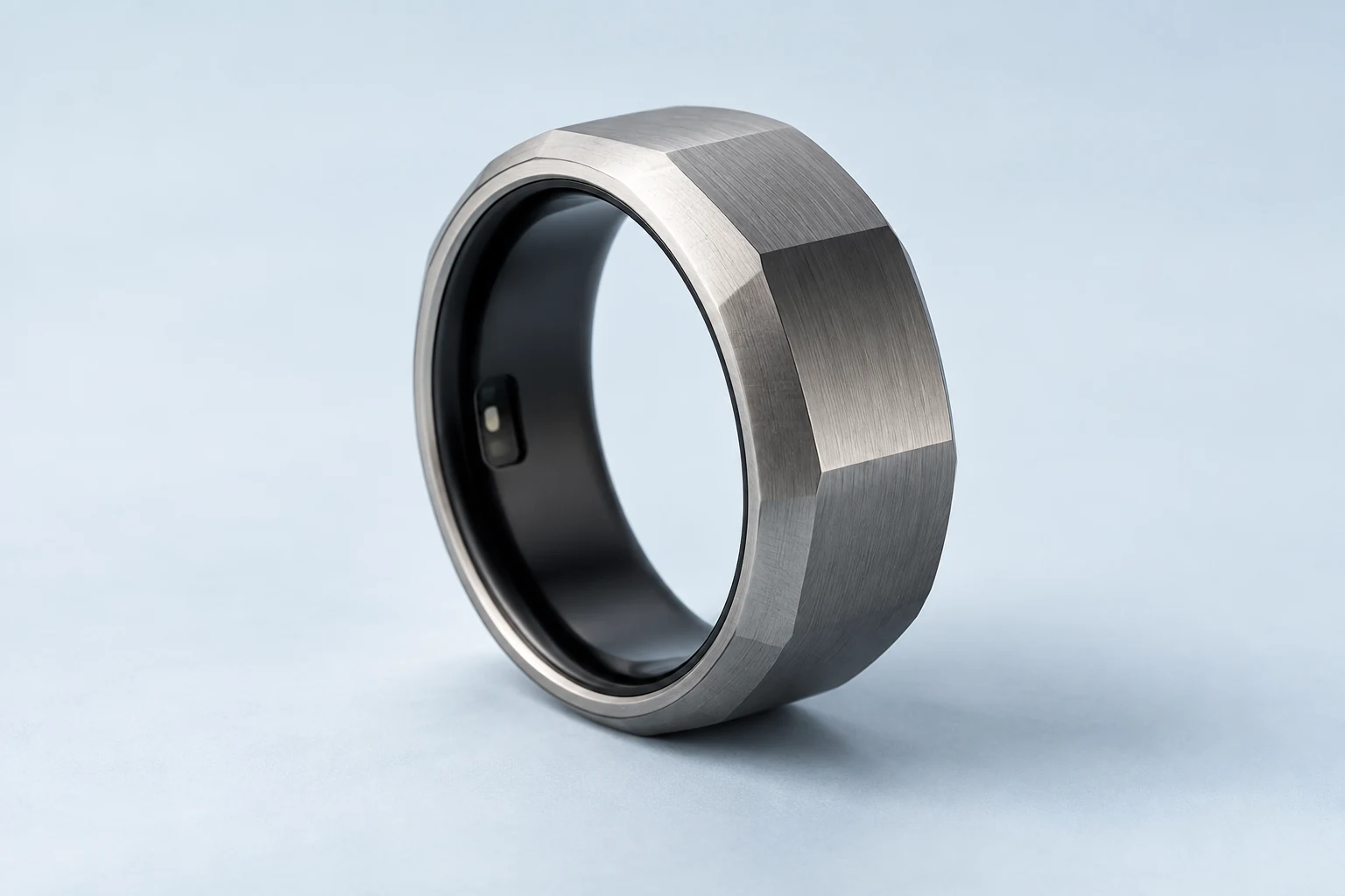 AI-generated macro concept of a graphite activity ring with a smooth dark liner and unlit inner window.